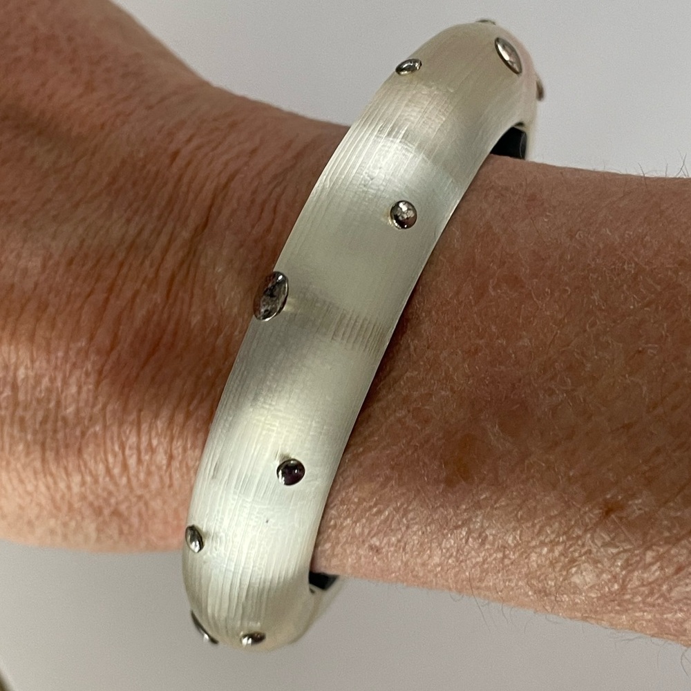 Alexis Bittar Frosted White Hinged Bangle Bracelet with metallic silver dots